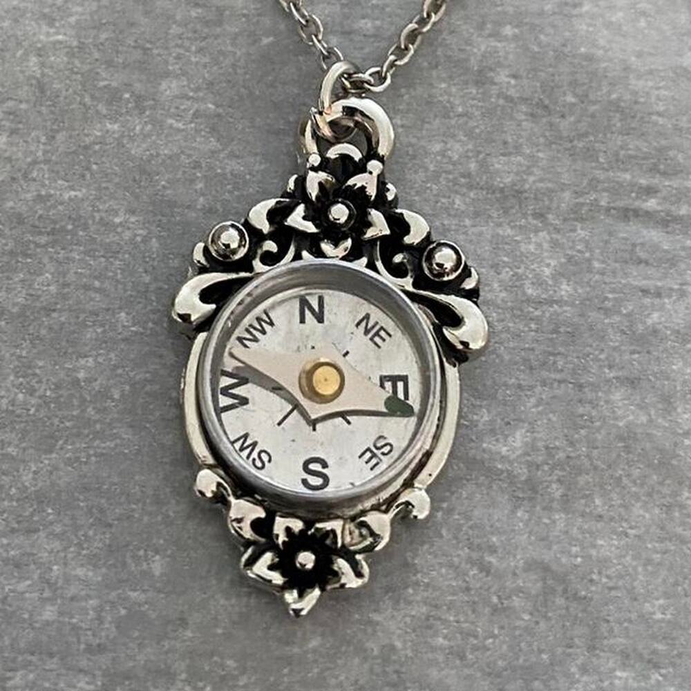 Silver tone compass necklace